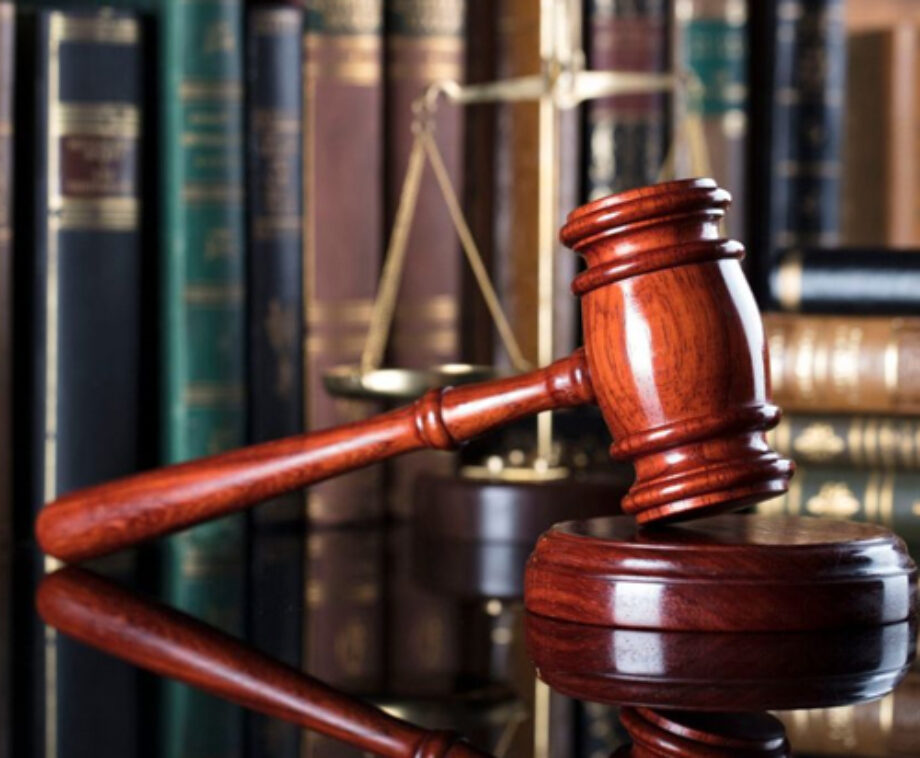 Gavel on Table With Books in the Background