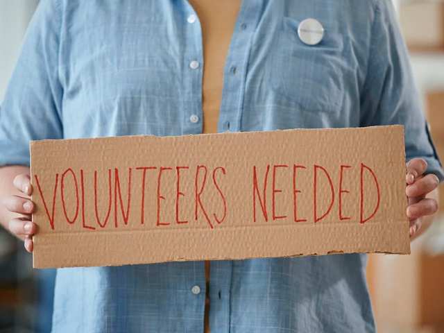 Woman Holding Volunteer Sign