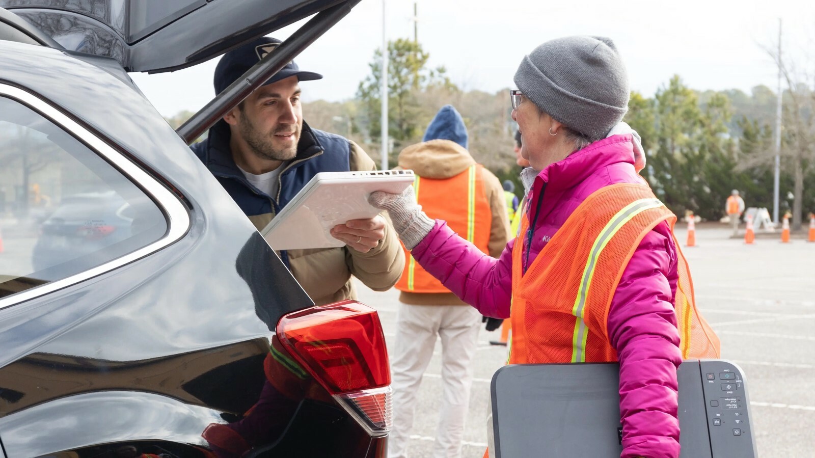 Man dropping off old laptop and printer at VA Aquarium E cycling event