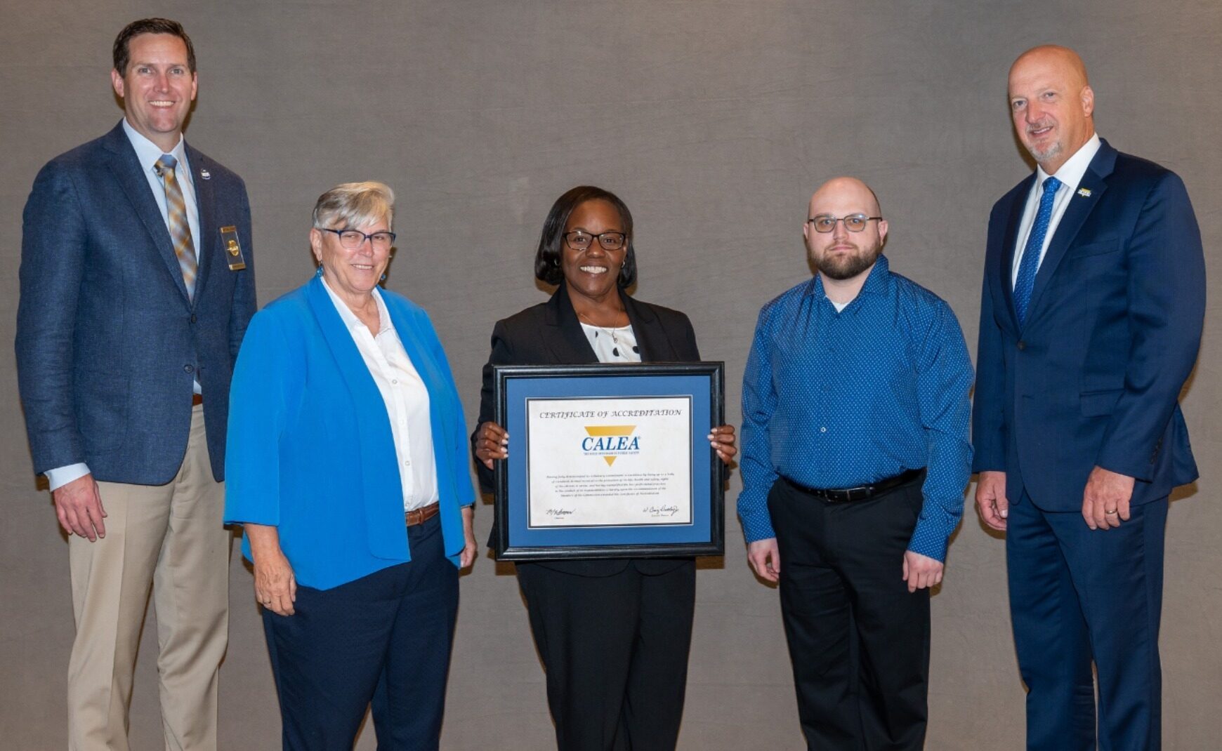 ECCS Staff accepting certificate of accreditation from CALEA