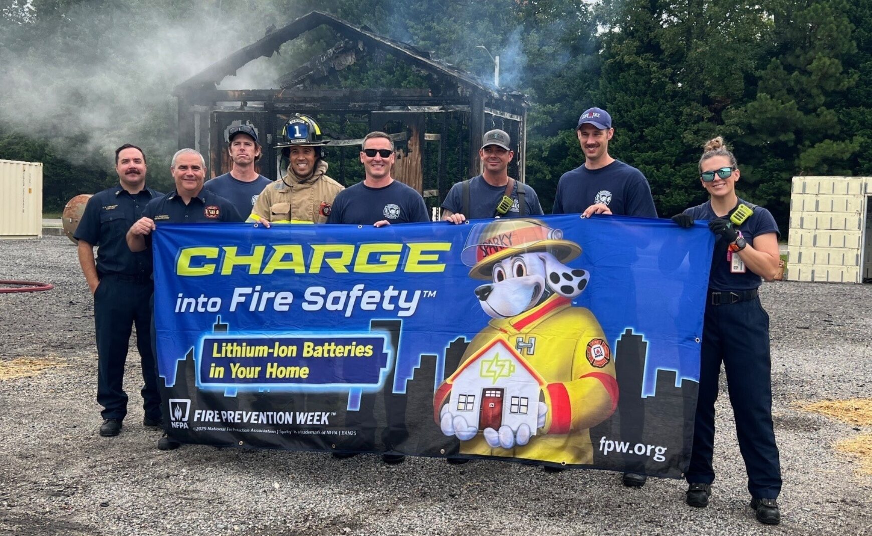 Firefighters holding banner promoting Fire Prevention Week