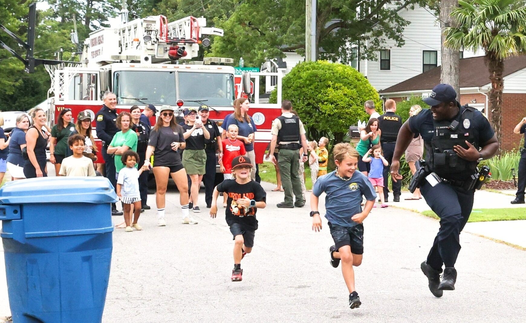 Kids and cop racing at National Night Out 2024