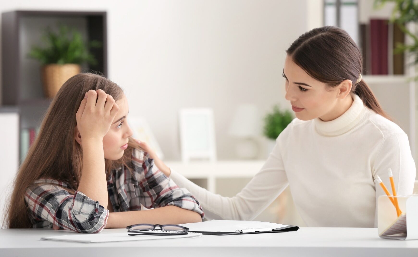 Therapist consoling young girl