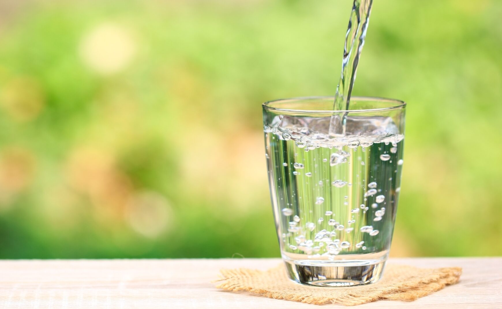 Water being poured into glass on table