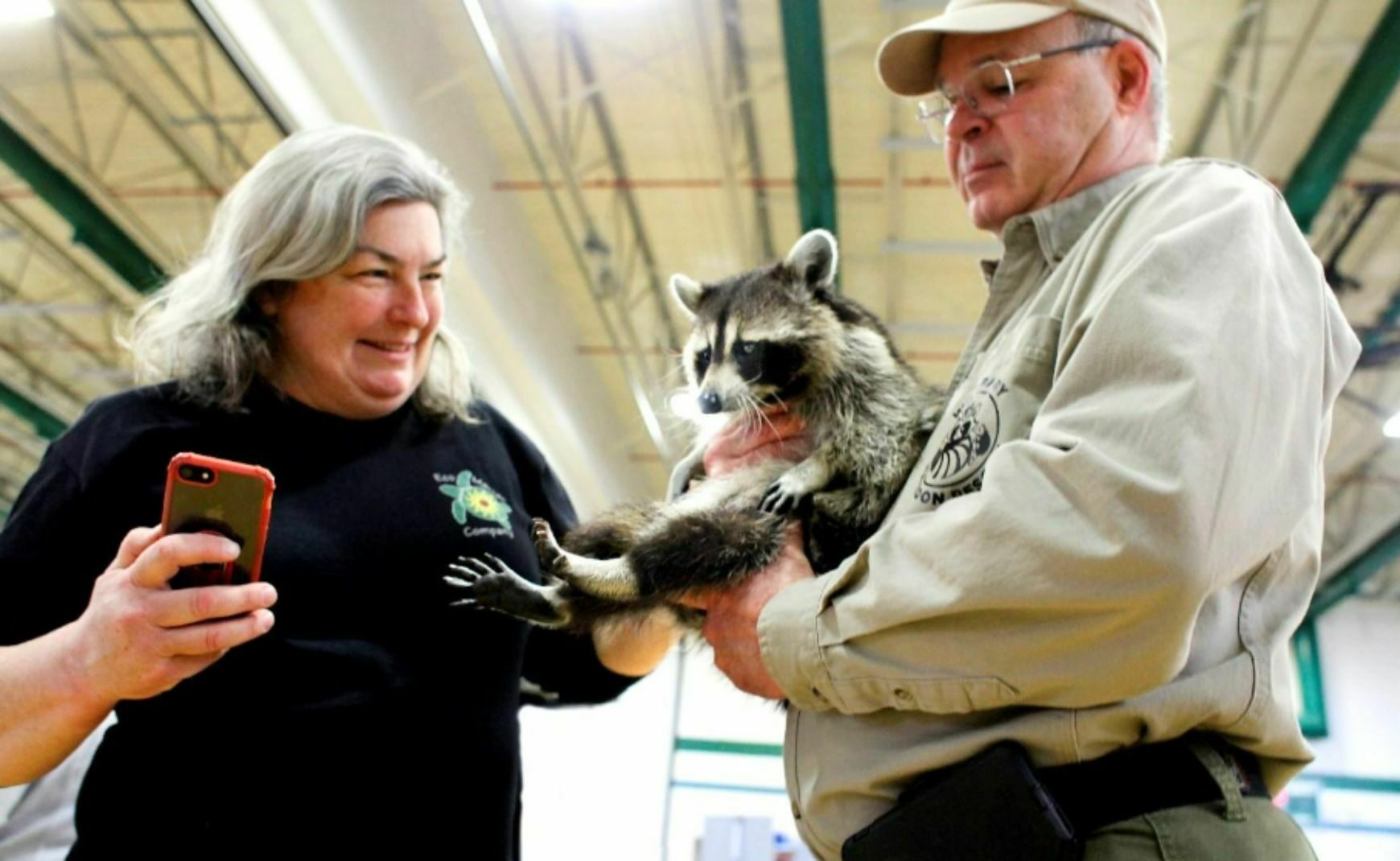 Woman petting racoon at Winter Wildlife Festival