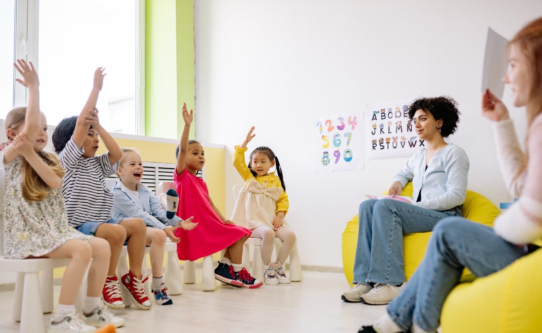 Children raising their hands in a classroom