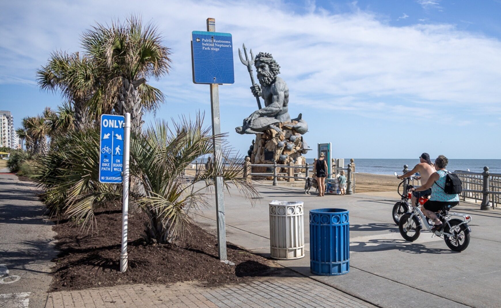 Couple riding e bikes on Virginia Beach Boardwalk
