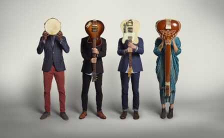 American Patchwork Quartet Band Members Holding Instruments in Front of Their Faces