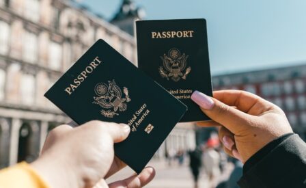Hands holding U S passports