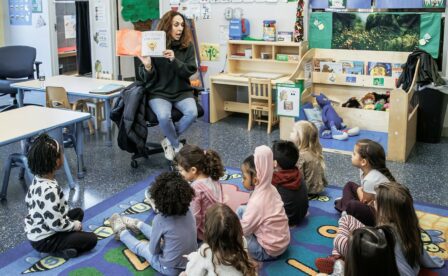 Volunteer reading to children during Read Across America Day event in 2025
