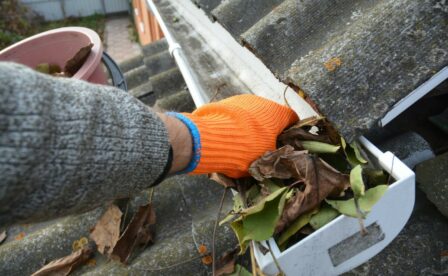 Clearing leaves from rain gutters