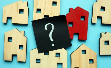 Graphic of wood houses and a question mark