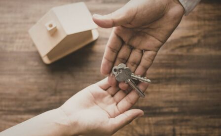 Hands holding keys and passing to another hand