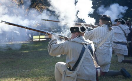 Three men reenacting a historic battle