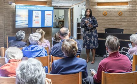 Woman talking to audience as part of speakers bureau