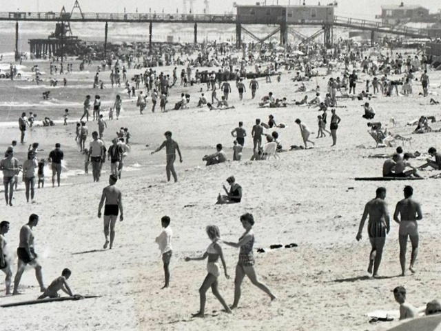 Udated black and white photo of beachgoers at the Virginia Beach Oceanfront