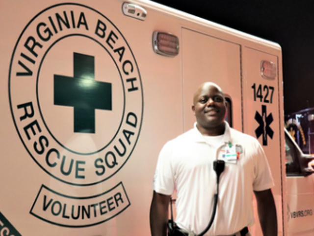 Paramedic in Front of Ambulance