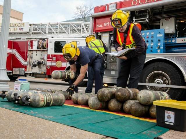 Volunteer firefighters inspecting oxygen tanks laying on ground Get Involved