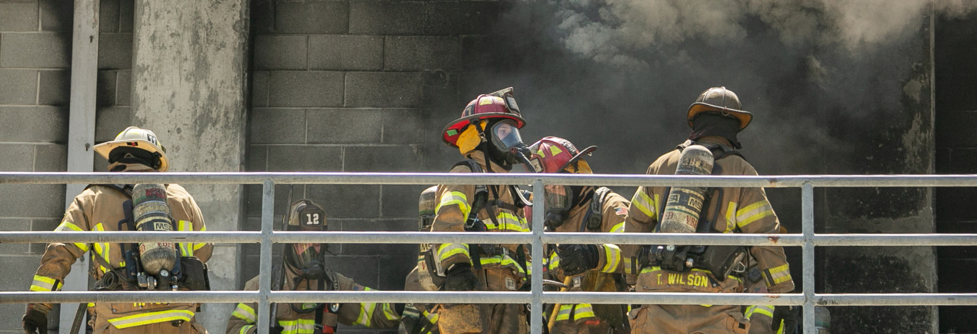 Firefighters preparing to enter a burning building for training exercise