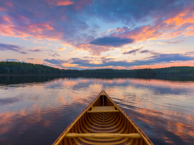 Canoe in the water at sunset heading to shoere Strategic Plan featured nav