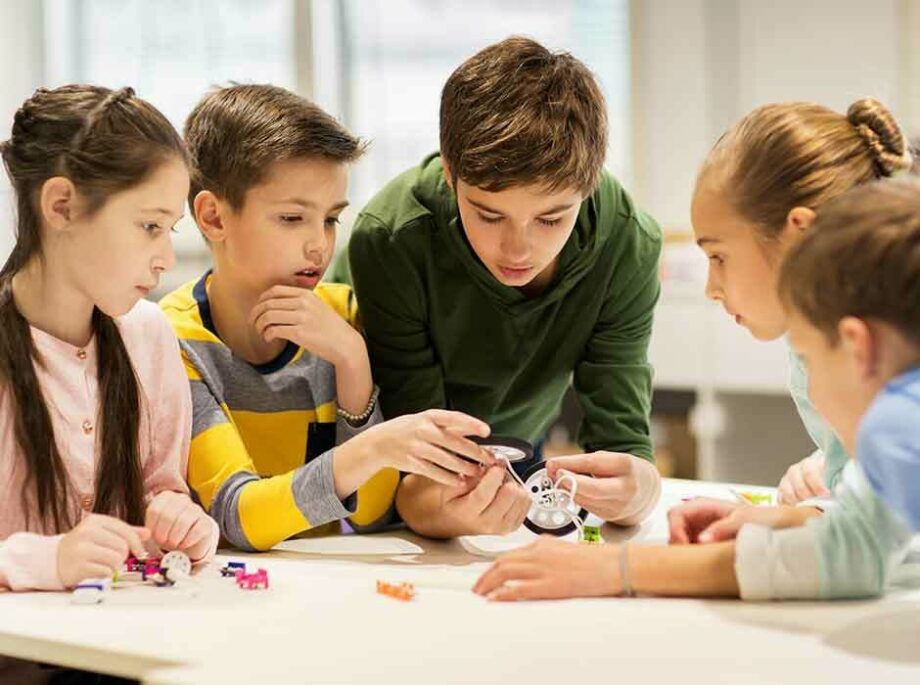 Middle school children playing with toys