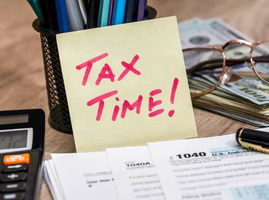 Tax time text on paper and 1040 forms