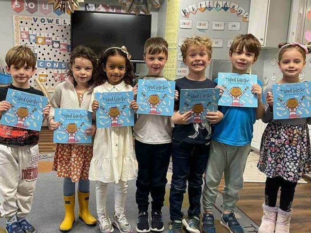 Children holding books carousel