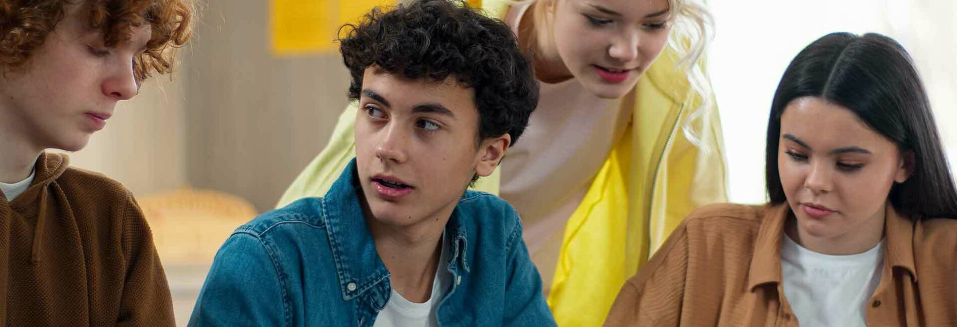 Four teenagers brainstorm ideas