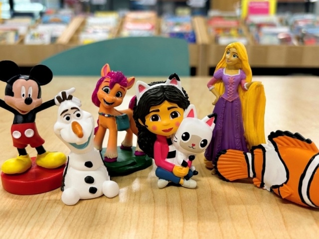Group of Tonie figurines including Nemo Mickey Olaf Rapunzel and more