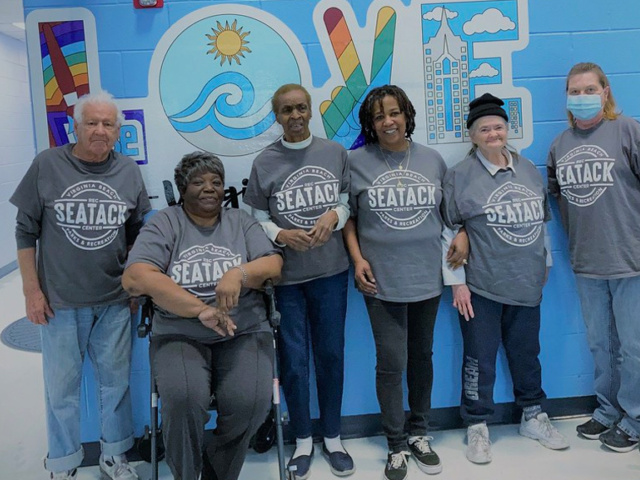 Seniors Standing Next to Wall