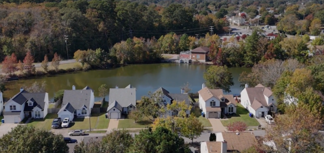 View of neighborhood from the air with body of water behind homes