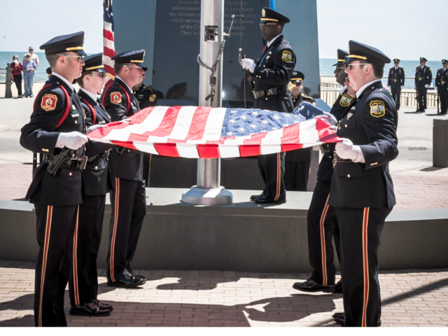 Honor guard members folding a U S flag at Law Enforcement Officer Memorial