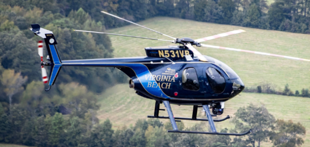 VBPD helicopter in flight over field and trees