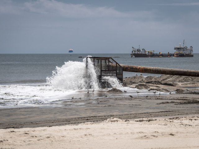 Dredge equipment filtering water on beach