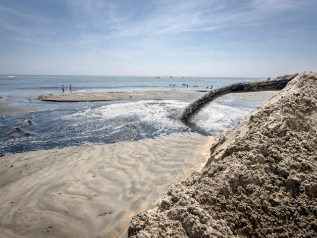 Dredged sand being deposited onto beach