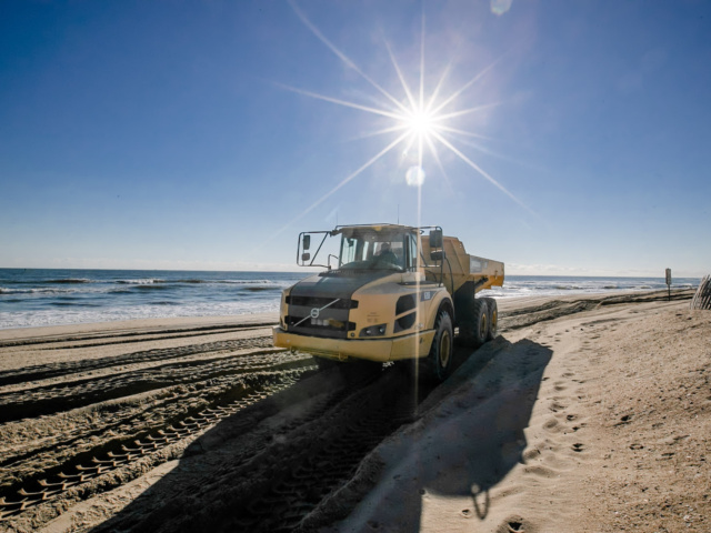 Dumptruck on beach hauling sand