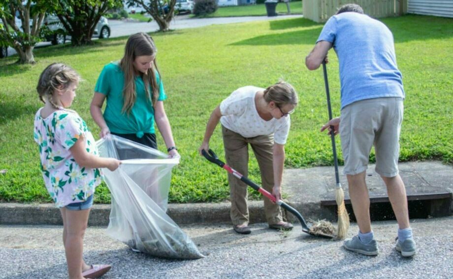 Family cleaning gutter area around drain