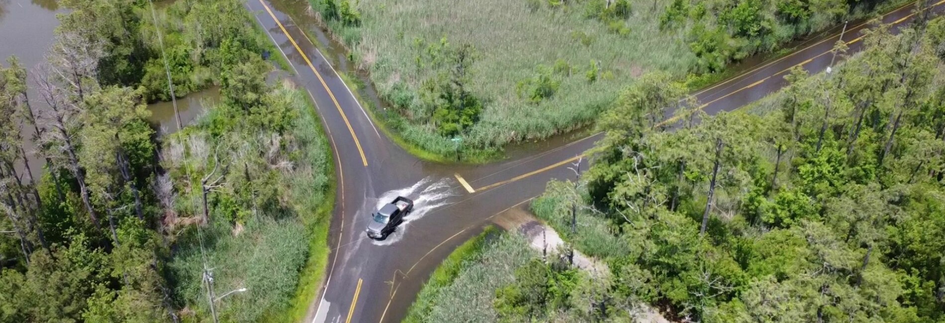 Aerial image of truck drving through flooded intersection