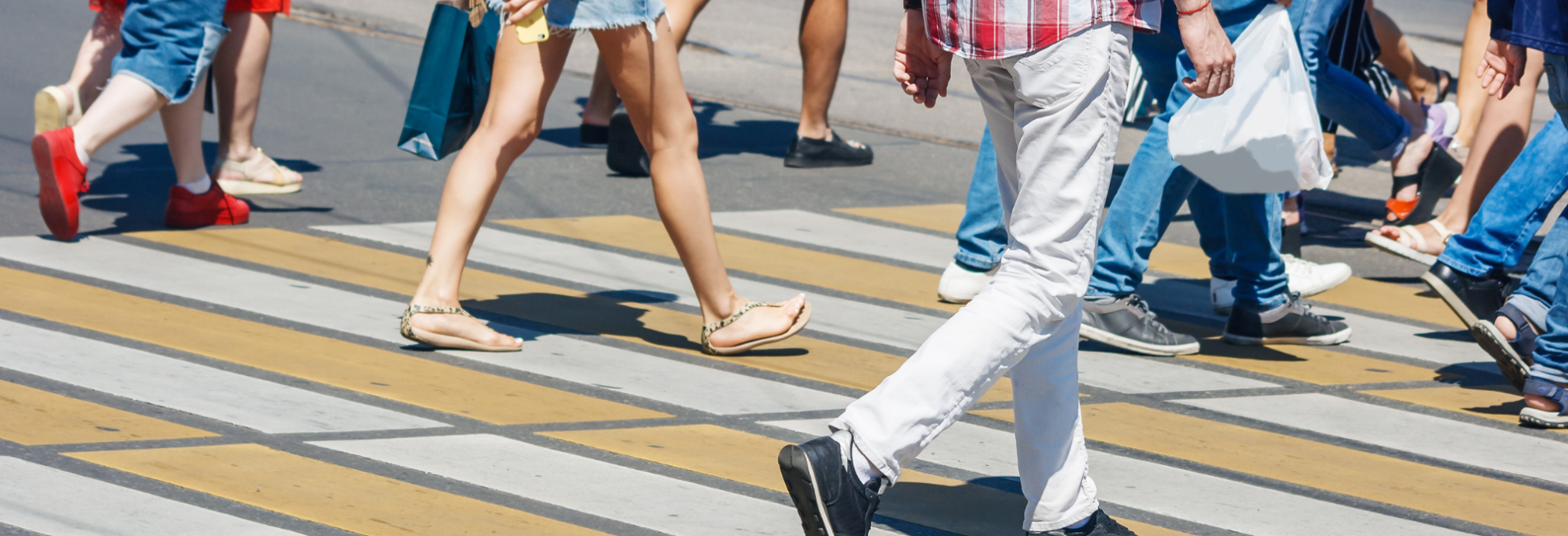 Group of pedestrians walking across street in crosswalk