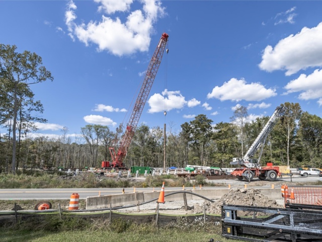 Ground view of Elbow Road project site with piledriving crane heavy equipment and current road