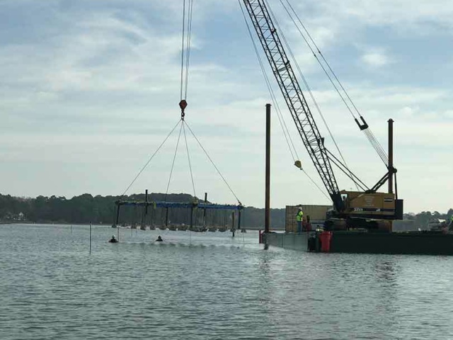 3 Divers receiving install in water